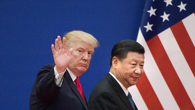 (FILES) In this file photo taken on November 9, 2017 shows US President Donald Trump (L) and China's President Xi Jinping leaving a business leaders event at the Great Hall of the People in Beijing. - President Donald Trump on September 18, 2018 accused China of seeking to influence upcoming US elections by taking aim at his political support base in the countries' escalating trade war. "China has openly stated that they are actively trying to impact and change our election by attacking our farmers, ranchers and industrial workers because of their loyalty to me," Trump tweeted.Trump's comments came a day after he targeted another $200 billion in Chinese imports with tariffs starting next week, drawing an immediate vow of retaliation from Beijing. (Photo by Nicolas ASFOURI / AFP)