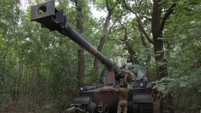 Ukrainian servicemen work next to a Polish 155mm self-propelled tracked gun-howitzer Krab at a position on the front line in the Donetsk region in July. Picture: AFP