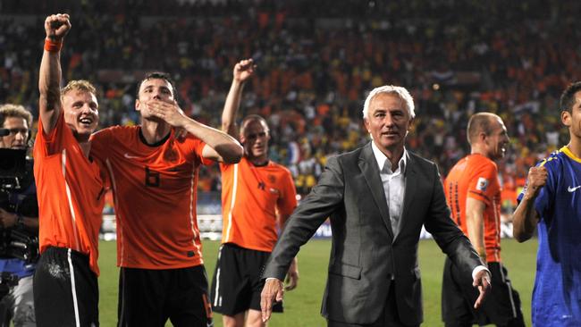 Bert Van Marwijk (c) with Dirk Kuyt (l) and Mark van Bommel (2nd l).