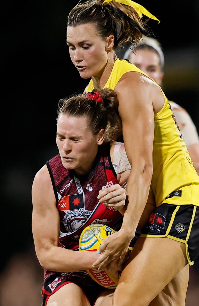 Alexandra Morcom of the Bombers is tackled by Eilish Sheerin of the Tigers during the 2024 AFLW Round 09 match between the Essendon Bombers and the Richmond Tigers at TIO Stadium. Picture: Dylan Burns/AFL Photos via Getty Images)