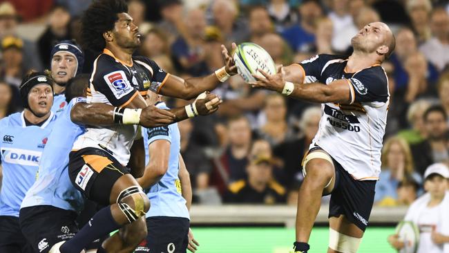 The Brumbies’ Henry Speight (left) and Lachie McCaffrey go for the ball on Saturday night.