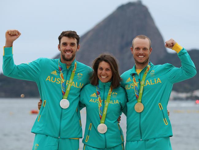 Australia’s Jason Waterhouse, Lisa Darmanin and Tom Burton pose for a portrait in front of Sugarloaf Mountain after winning the silver medal in the Nacra 17 Mixed Medal Race and Gold in the Men's Laser at Marina da Gloria during day 11 of the Rio 2016 Olympic Games. Picture: Brett Costello