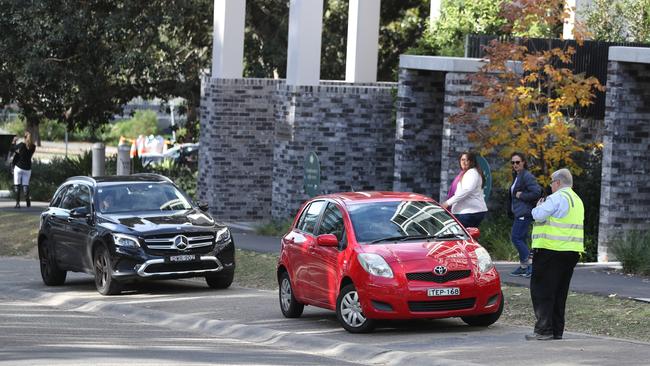 A parking officer near the Sydney Olympic Park Vaccination Centre. Image: John Grainger