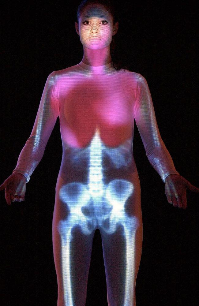 Projection showing spread of influenza throughout the body being shown on a model wearing bodysuit of a skeleton.