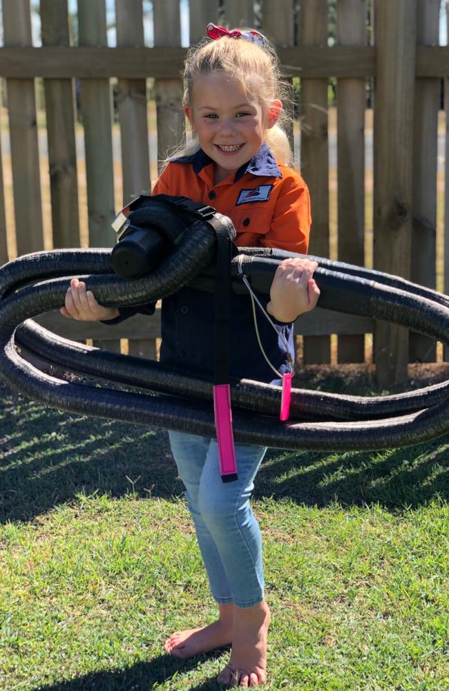 Alliara Leppard holding a synthetic, light-weight coupling her dad developed to replace a 110kg alternative used at QLD mine sites. Picture: Supplied