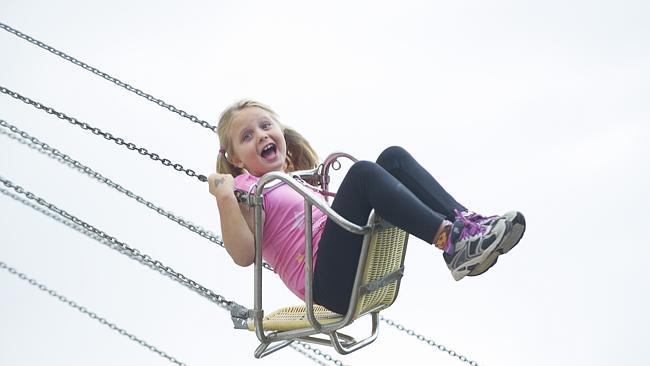 Seat of power ... Maya Kerin, 6, was among the riders on the Flying Swings, which spun around more than 48,000 times during the Easter Show. Picture: Melvyn Knipe