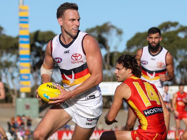 ADELAIDE, AUSTRALIA - MARCH 06: Brodie Smith of the Crows evades Lachie Weller of the Suns during the 2020 Marsh Community Series match between the Adelaide Crows and the Gold Coast Suns at Flinders University Stadium on March 06, 2020 in Adelaide, Australia. (Photo by AFL Photos)