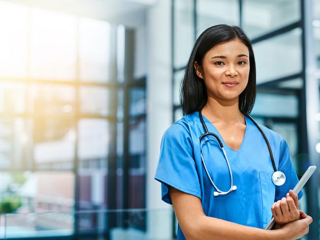 Portrait of a young nurse standing in a hospital