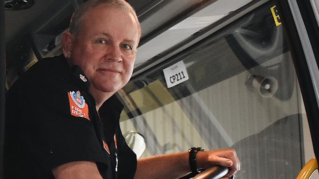 Brad Harrison hangs his gear up for the last time at Ballina Fire Station after 43 years as a firefighter. Picture: Tessa Flemming