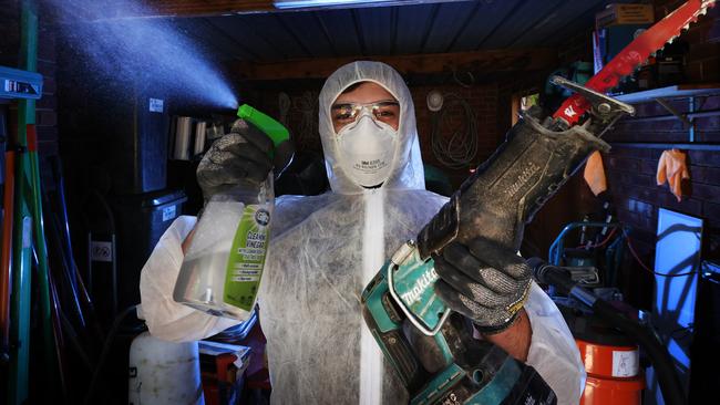 Steven Constantinou wearing a hazmat suit to clean mouldy Melbourne. Picture: David Caird