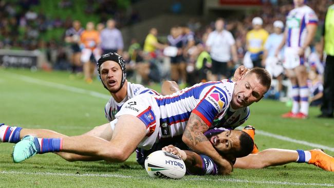 Josh Addo-Carr gets the ball over the try line to score while being tackled 2nd half. Pic: Michael Klein