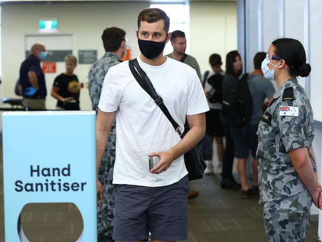 PERTH, AUSTRALIA - NOVEMBER 14: Passengers from Qantas flight QF937 from Brisbane walk from the processing area after being temperature tested and having their G2G pass verified by WA Police on arrival at Perth Airport on November 14, 2020 in Perth, Australia. Western Australia's hard border transitioned to a controlled interstate border as of 12:01 on Saturday, with travellers from Queensland, South Australia, Northern Territory, Tasmania and the ACT now permitted to enter the state. People arriving from Victoria and New South Wales will be required to self-quarantine for 14 days and take a COVID-19 test on day 11, while all other travellers will be required to undergo a health screening and temperature check on arrival and declare they haven't come from Victoria or NSW. Travel arrangements also need to be registered on the G2G Pass app. (Photo by Paul Kane/Getty Images)