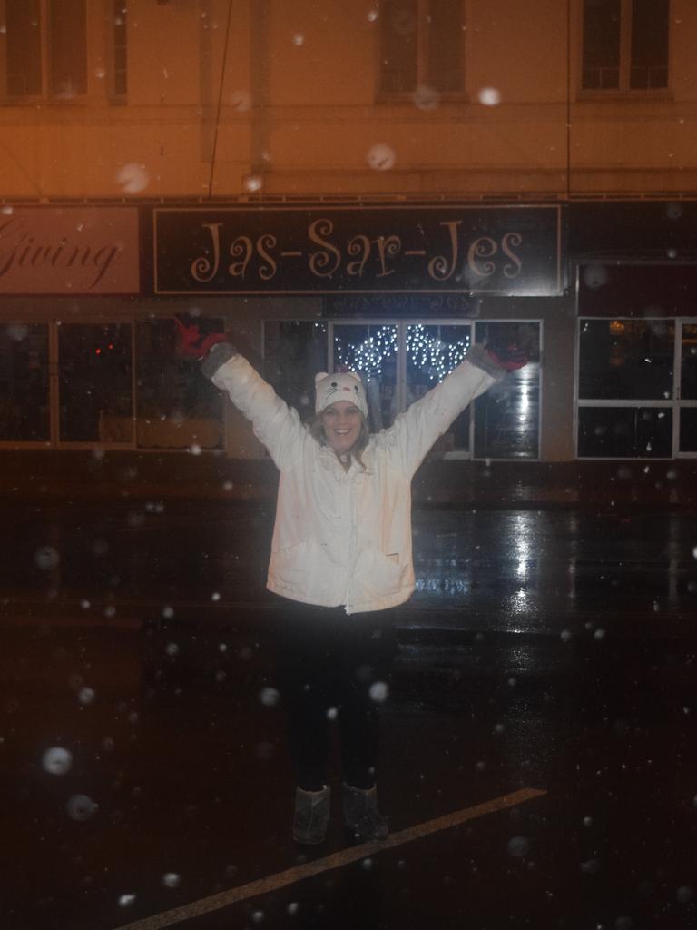 Stanthorpe's Veronica Bentley laps up the snow in the main street in the early hours of July 17, 2015. Photo: Alex Nolan / Stanthorpe Border Post