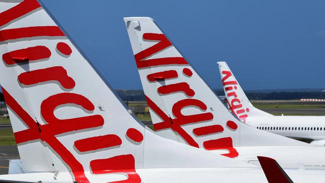 SYDNEY, AUSTRALIA - NCA NewsWire Photos FEBRUARY, 4, 2021: Virgin Australia aircraft are seen on the tarmac at Sydney Domestic Airport, Sydney. Virgin Australia says the end of JobKeeper in March could signal a mass shedding of workers if no further support is provided to the struggling aviation industry which has been out of action for almost one year. Picture: NCA NewsWire/Bianca De Marchi