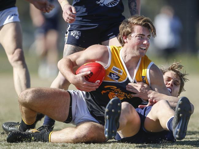 Frankston YCW’s Michael Debenham is tackled in last year’s finals series. Picture: Valeriu Campan