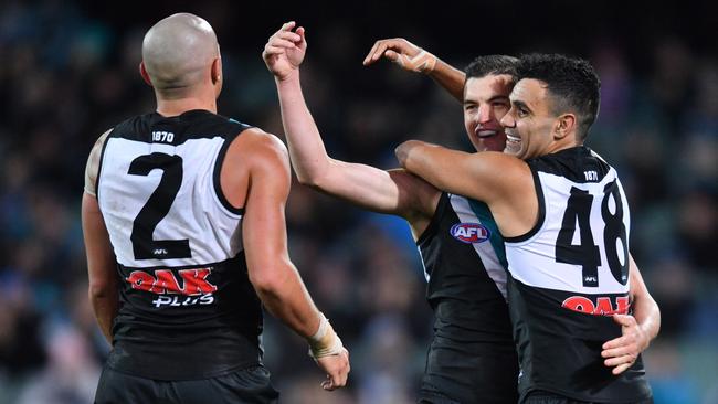 Port Power players react after scoring during the Round 13 AFL match between the Port Adelaide Power and the Western Bulldogs at Adelaide Oval in Adelaide, Thursday, June 14, 2018. (AAP Image/David Mariuz) NO ARCHIVING, EDITORIAL USE ONLY