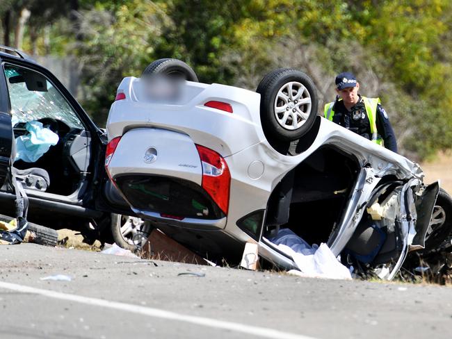 Emergency services attend a fatal crash involving three vehicles just north of the Yabulu Overpass. Picture: Alix Sweeney