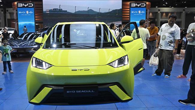 People look at a BYD Seagull car by the Chinese electric vehicle manufacturer. Picture: Lillian Suwanrumpha/AFP