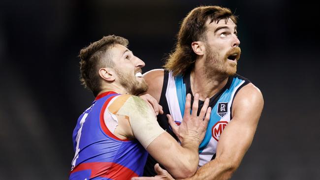 Marcus Bontempelli is held out of a ruck contest by Scott Lycett.