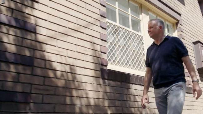 Anthony Albanese walks past his old home.