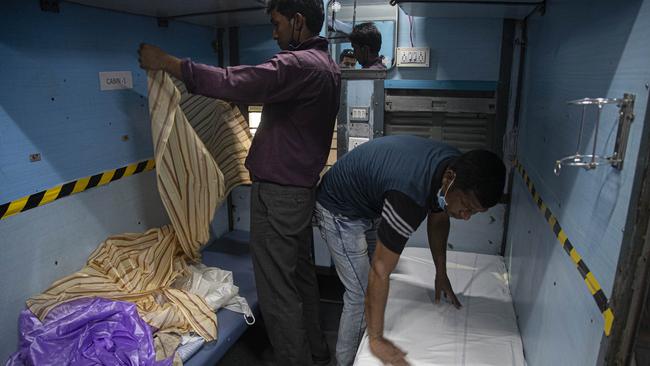 Indian rail workers convert a carriage to an isolation ward. Picture: AP