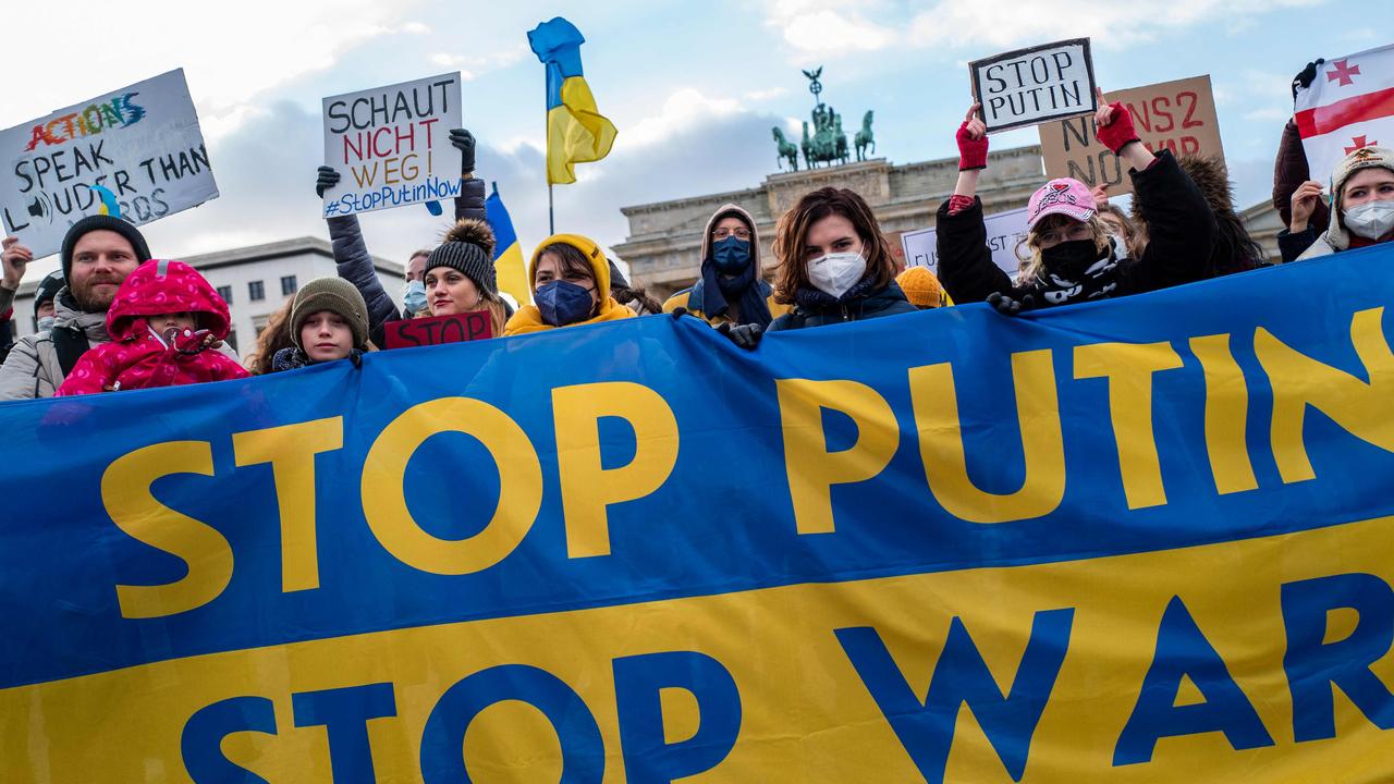 Demonstrators display a banner in the colours of the Ukrainian flag reading ‘Stop Putin, Stop War’ during a protest at Berlin's Brandenburg Gate on January 30. Picture: John MacDougall/AFP