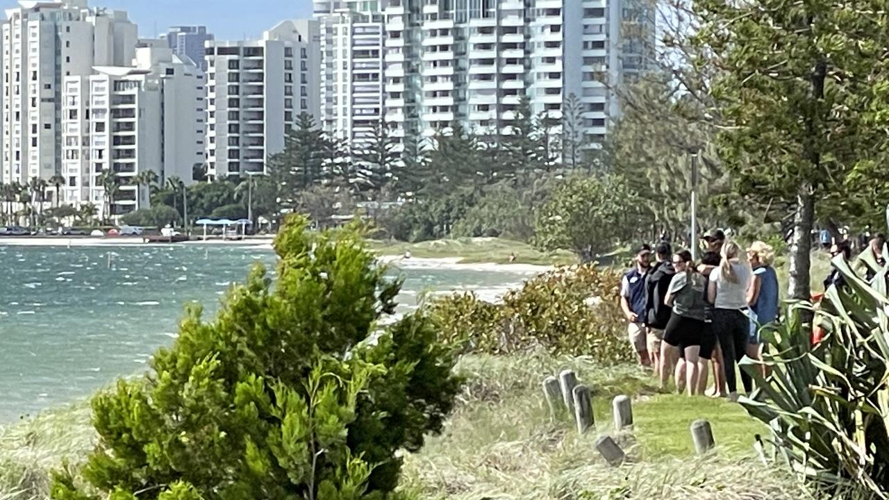 People watch on during the search for Mr Krenskewho went missing while swimming off Wave Break Island on Friday morning.