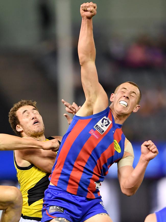 Harvey Hooper goes the defensive fist for Port Melbourne.