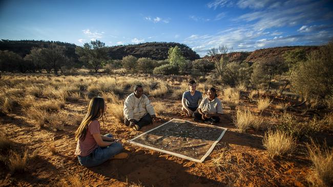 Visitors learning about Aboriginal art during a Karrke Aboriginal Cultural Experience. Picture: Tourism NT.