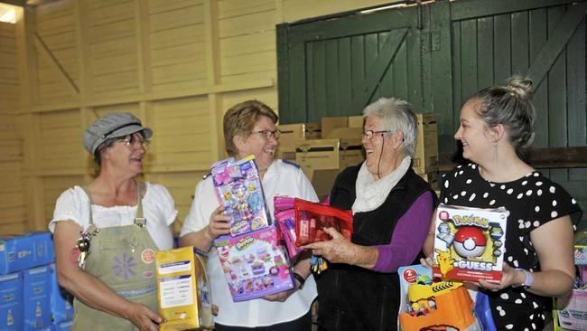 EASING COSTS: Mend and Make Do president Ursula Tunks, Salvation Army volunteer Judy Salter, Grafton Showground secretary Carole Bryant and Jaide McGowan, from Clarence River Domestic and Family Violence Specialist Services with some of the donations. Picture: Kathryn Lewis