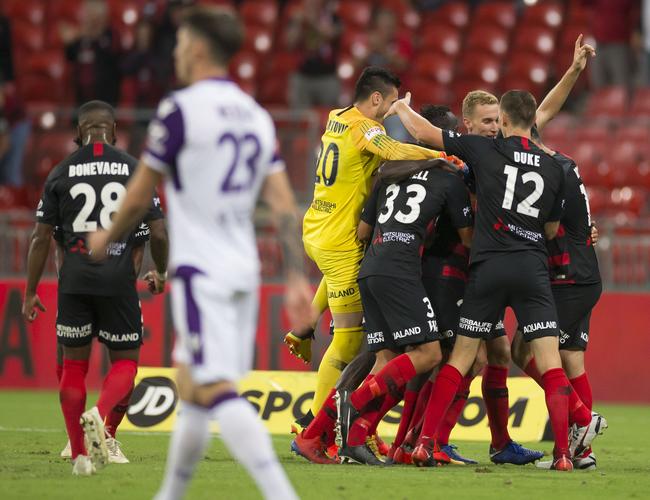Western Sydney Wanderers celebrate Tarek Elrich’s goal to seal a draw.