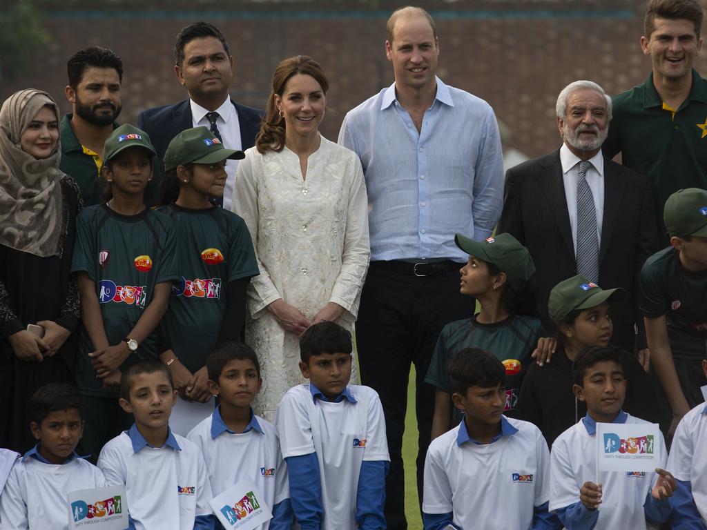 Prince William and his wife Kate, Duchess of Cambridge pose with Pakistani students during their visit at the Pakistan Cricket Academy. Picture: AP Photo/B.K. Bangash