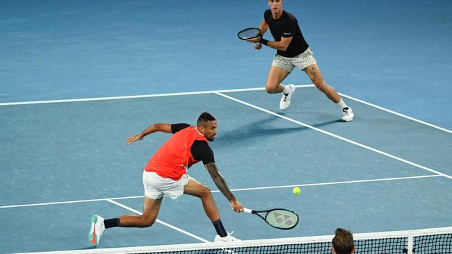 Australia's Nick Kyrgios hits a return as he plays with Australia's Thanasi Kokkinakis