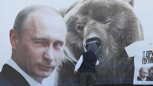 Russian President Vladimir Putin and a bear.