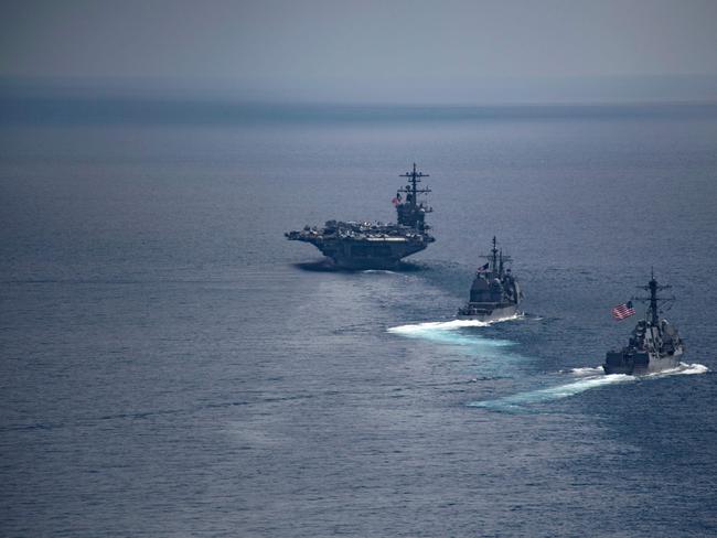 The aircraft carrier USS Carl Vinso leading the Arleigh Burke-class guided-missile destroyer USS Michael Murphy and the Ticonderoga-class guided-missile cruiser USS Lake Champlain. Picture: AFP