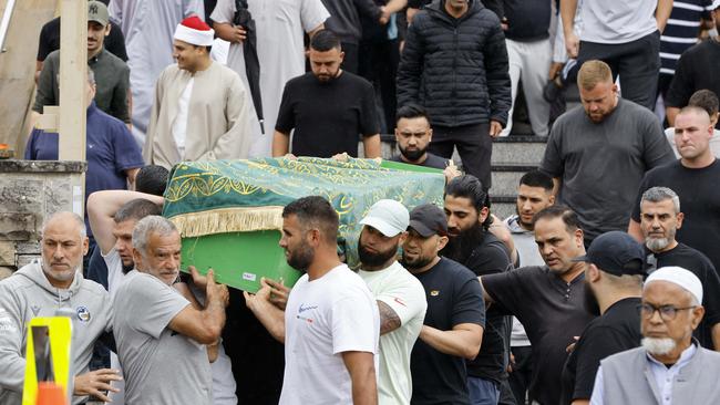 Acherkouk’s coffin is carried out out after the service.