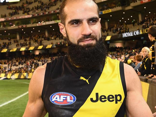 MELBOURNE, AUSTRALIA - JUNE 25:  Bachar Houli of the Tigers high fives fans after winning the round 14 AFL match between the Richmond Tigers and the Carlton Blues at Melbourne Cricket Ground on June 25, 2017 in Melbourne, Australia.  (Photo by Quinn Rooney/Getty Images)