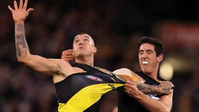 Jacob Weitering tries anything he can to stop Dustin Martin in Round 14. Picture: Michael Klein