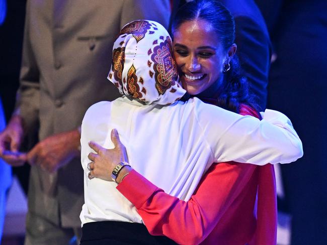 Meghan Markle is greeted by Somali-born US former model and One Young World councillor Halima Aden. Picture: AFP