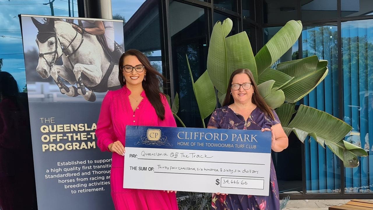 Toowoomba Turf Club CEO Lizzy King (right) presents a donation to Kim Duffy from Racing Queensland.