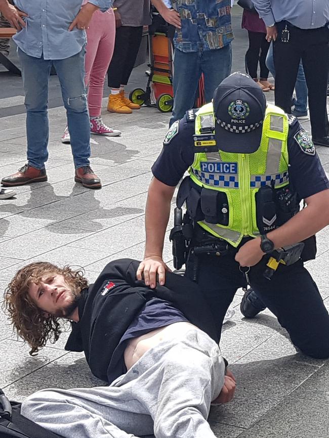 Barry Siecker is arrested after a busker was bashed with a ukulele in Rundle Mall. Picture: Shaun Hollis.