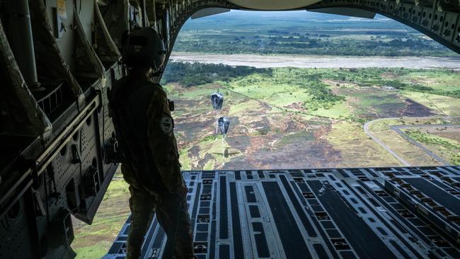 A US Air Force 15th Operational Support Squadron loadmaster delivers an airdrop from a C-17A Globemaster III at Nadzab in Papua New Guinea, as part of Exercise Global Dexterity in December 2023. Picture: Department of Defence