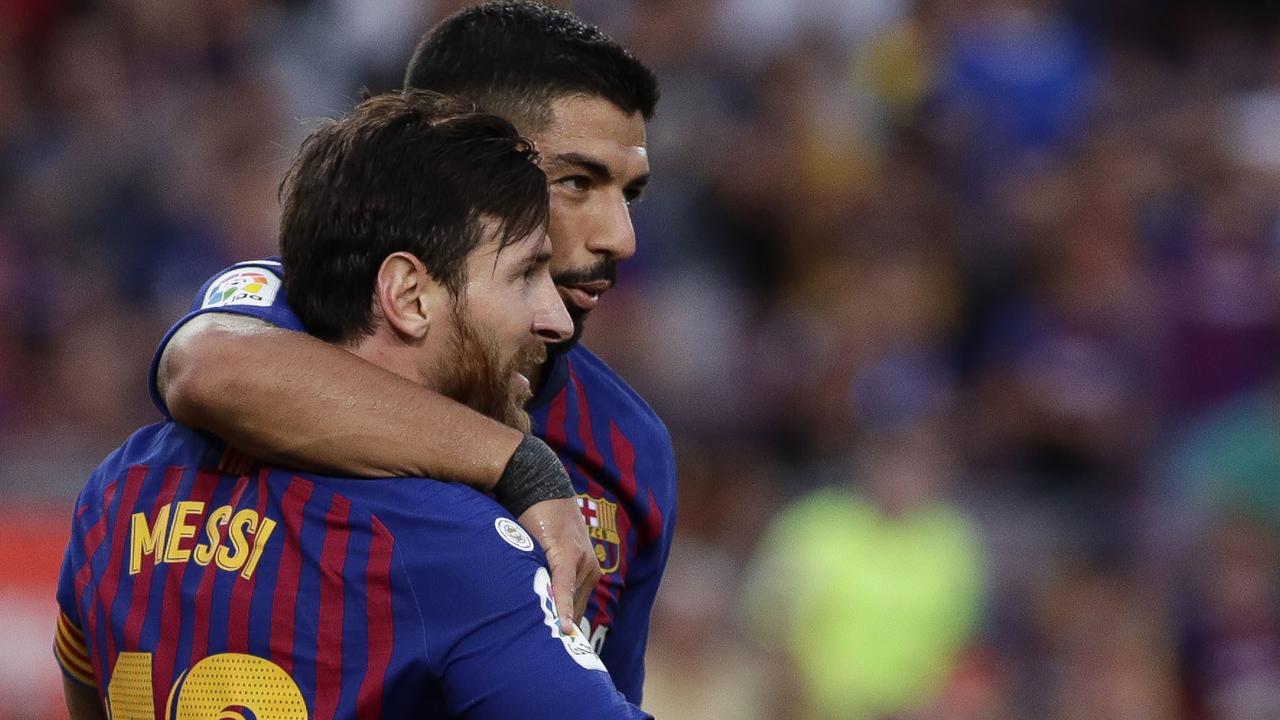 Barcelona's Lionel Messi celebrates with teammate Luis Suarez after scoring his side's sixth goal.