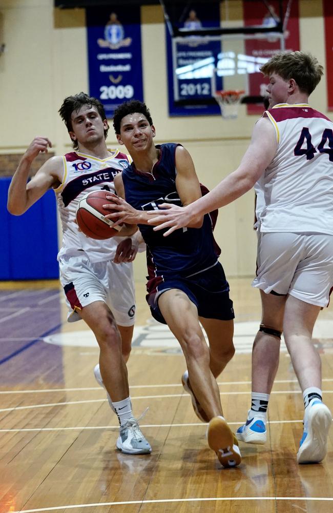 Jaylen Pitman (centre) and Liam Hude (left) in action.