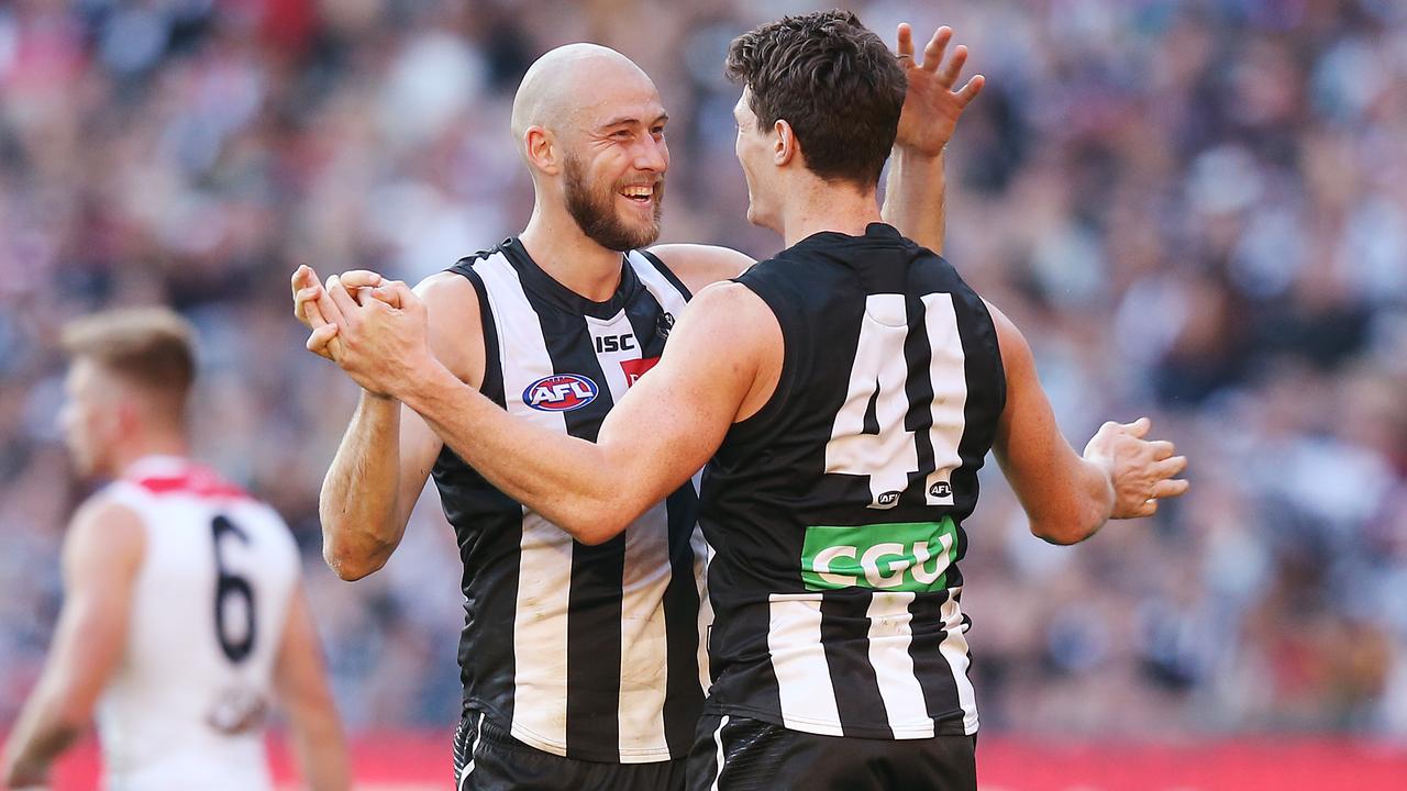 Ben Reid and Brody Mihocek celebrate a goal at the MCG on Saturday.