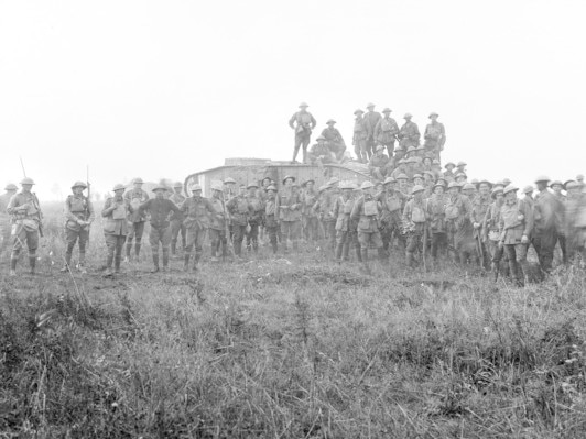 A tank crew joins members of the 5th Australian Infantry Brigade around a British tank on August 8, 1918, described by German general Erich Ludendorff as ‘the black day of the German Army’. Picture: Australian War Memorial