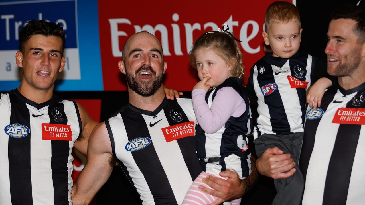 Steele Sidebottom (centre) and Jeremy Howe (right) sing the Collingwood song with kids after the 42-point win over Port Adelaide on Saturday. Picture: Dylan Burns / Getty Images