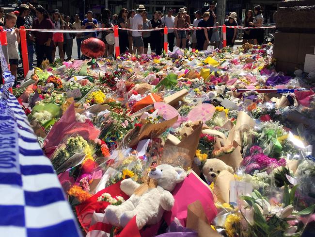 Flowers left in a floral tribute on Bourke St in Melbourne. Picture: AFP?Saeed Khan