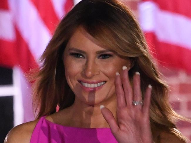 US President Donald Trump gestures as US First Lady Melania Trump waves to guests at the conclusion of the third night of the Republican National Convention at Fort McHenry National Monument in Baltimore, Maryland, August 26, 2020. (Photo by SAUL LOEB / AFP)