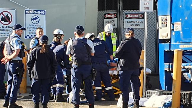 A man was freed after becoming trapped in a cardboard compacting machine in Liverpool.